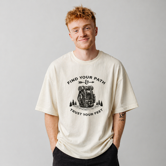 Man wearing a t-shirt with a motivational graphic and text on a plain background