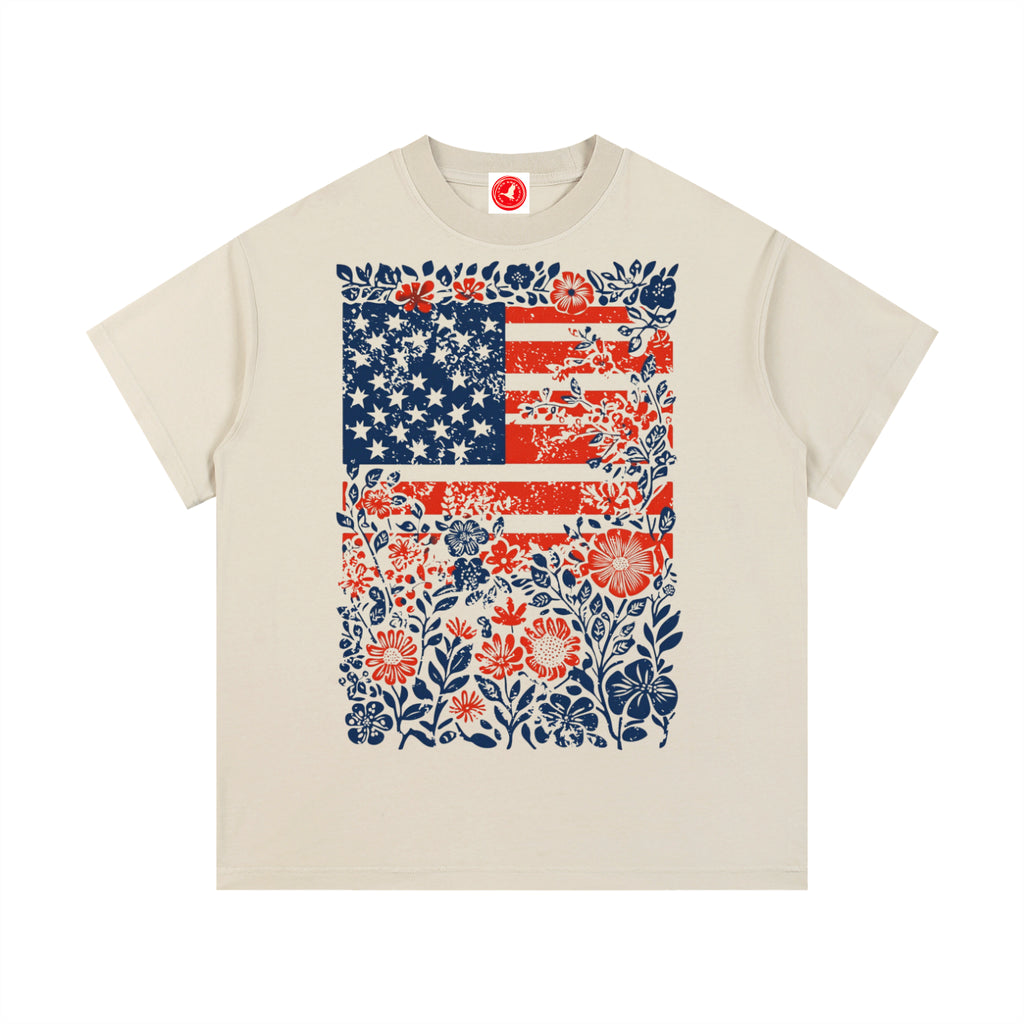Beige Floral Americana Flag graphic t-shirt featuring patriotic artwork blended with floral design and American heritage.