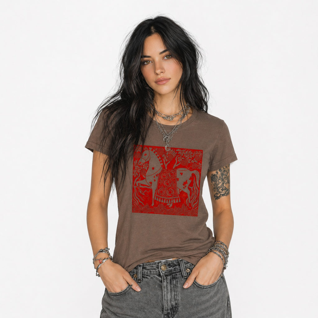 Woman wearing a brown Crimson Horse graphic t-shirt featuring folk art-inspired horse artwork celebrating tradition, creativity, and nature.