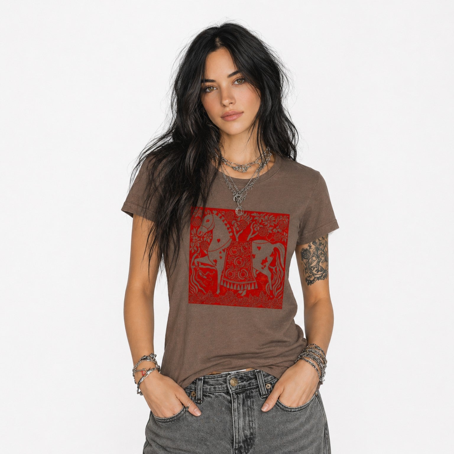 Woman wearing a brown Crimson Horse graphic t-shirt featuring folk art-inspired horse artwork celebrating tradition, creativity, and nature.