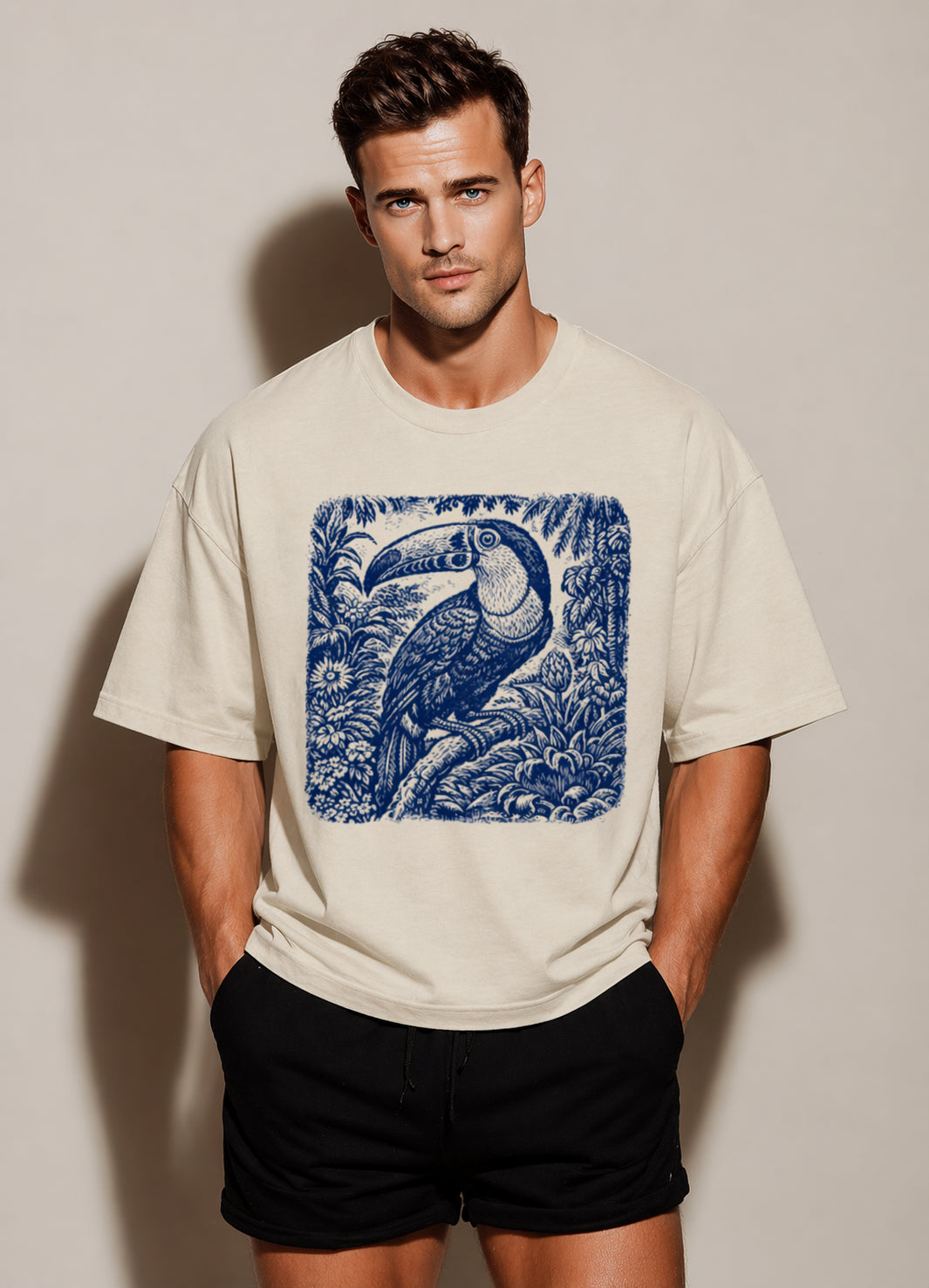 Man wearing a beigeVintage Botanical Bird graphic t-shirt featuring botanical bird artwork inspired by nature and vintage illustration.