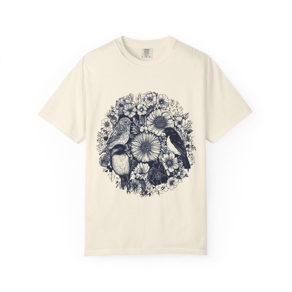 Beige t-shirt with black floral and bird design on a white background