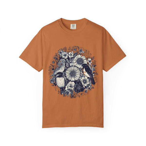 Brown t-shirt with nature-themed design featuring birds and flowers on a white background