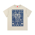 Beige Folk Skull graphic t-shirt featuring decorative skull artwork inspired by folk art and vintage illustration.