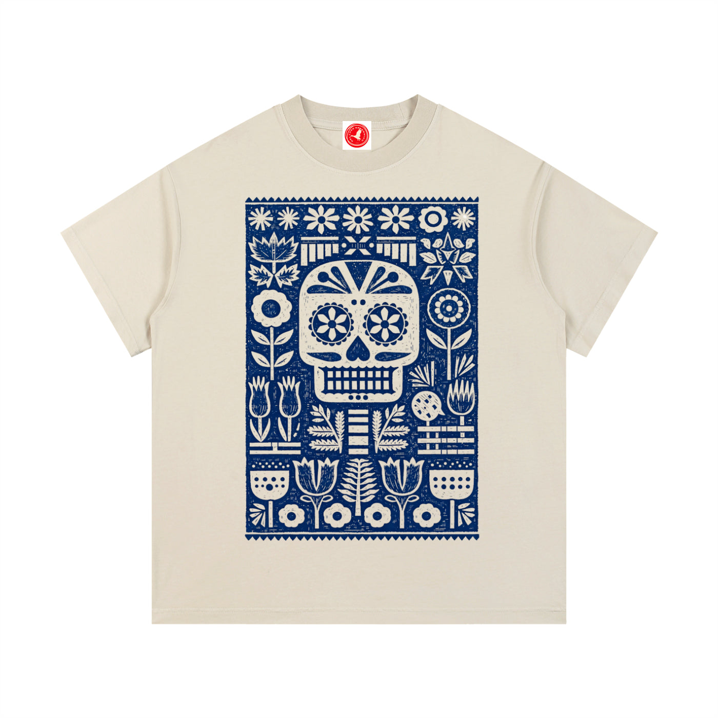 Beige Folk Skull graphic t-shirt featuring decorative skull artwork inspired by folk art and vintage illustration.
