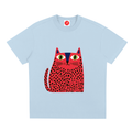 Light blue pink short-sleeve crewneck t-shirt featuring a stylized graphic of a red cat with black spots and green eyes on the front, displayed against a solid white background.