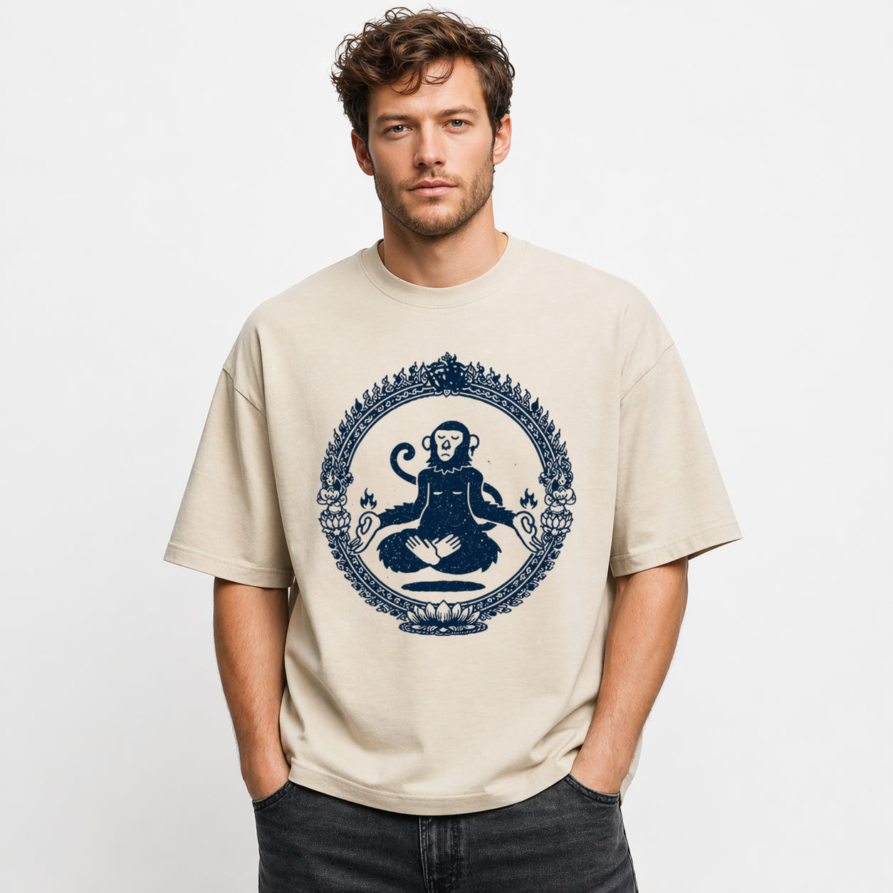 Man wearing a beige Sacred Monkey graphic t-shirt featuring artistic monkey artwork inspired by folklore, spirituality, and creative expression.