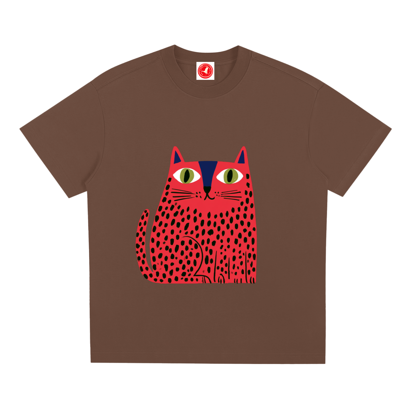 Brown pink short-sleeve crewneck t-shirt featuring a stylized graphic of a red cat with black spots and green eyes on the front, displayed against a solid white background.