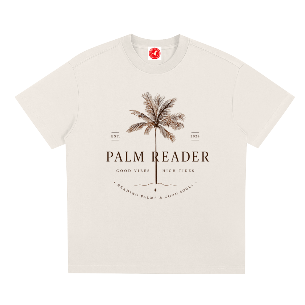 Beige Coastal graphic t-shirt featuring palm-themed artwork inspired by beach life, sunshine, and tropical escapes.