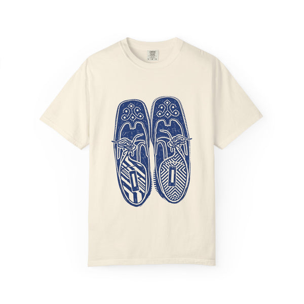Beige t-shirt with blue shoe design on a white background