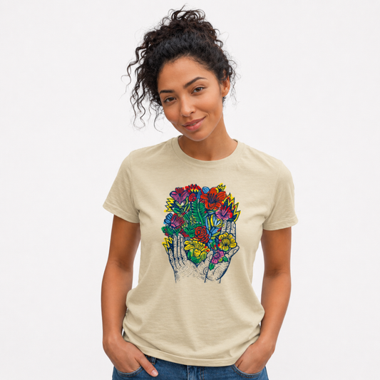 Woman wearing a beige t-shirt with a colorful floral design on a plain background
