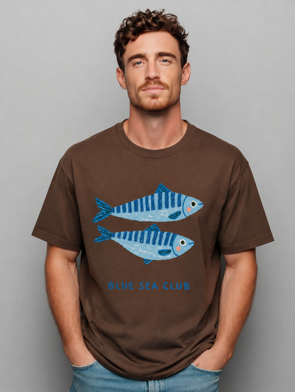 Man wearing a brown t-shirt with blue fish graphics and 'Blue Sea Club' text on a gray background