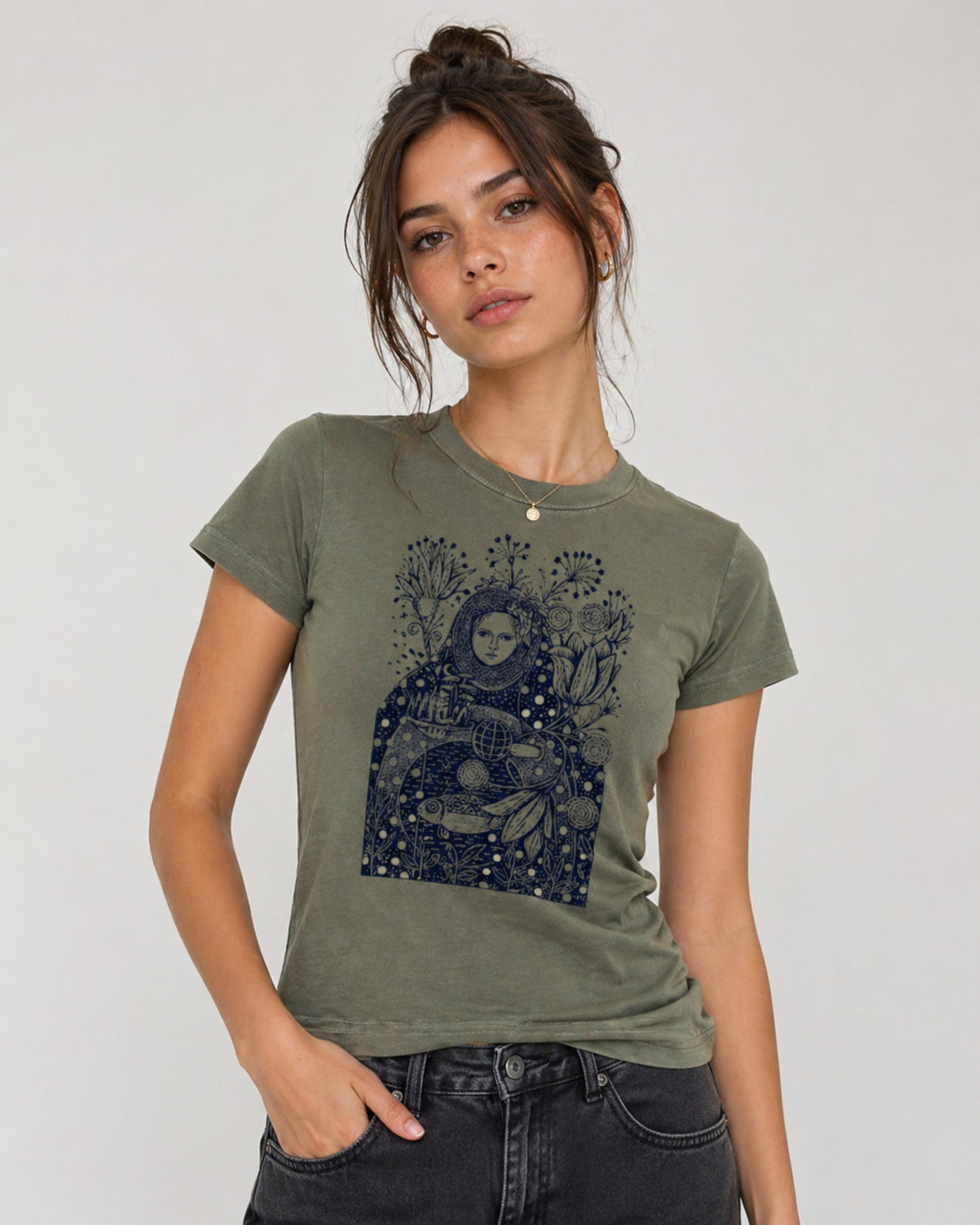 Woman wearing a green t-shirt with a graphic design on a plain background