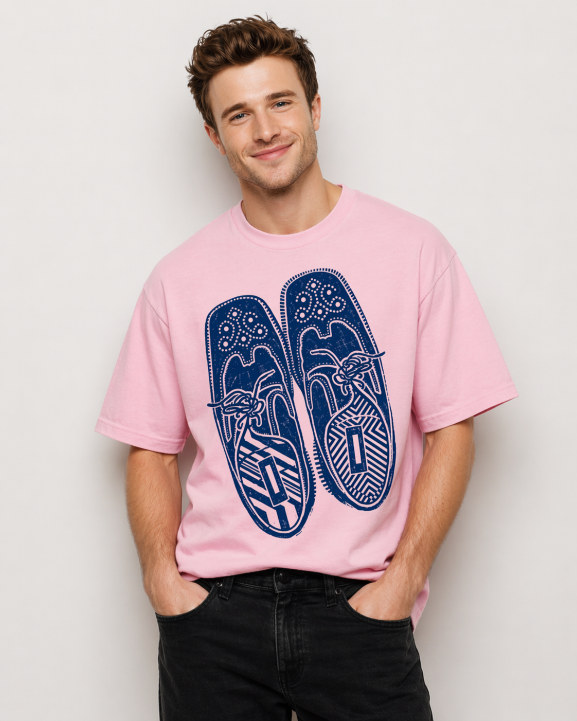 Man wearing a pink t-shirt with blue flip-flop design against a plain background