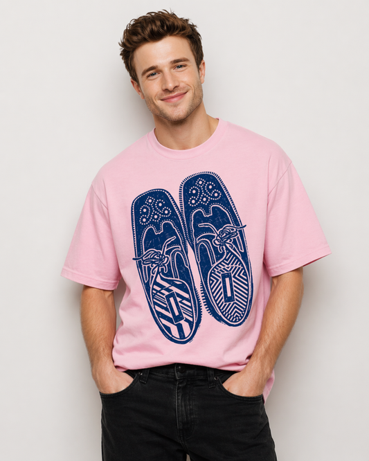 Man wearing a pink t-shirt with blue flip-flop design against a plain background