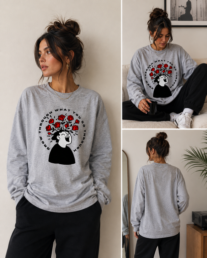 Woman wearing a gray sweatshirt with a graphic design, sitting on a couch, and standing in different poses.