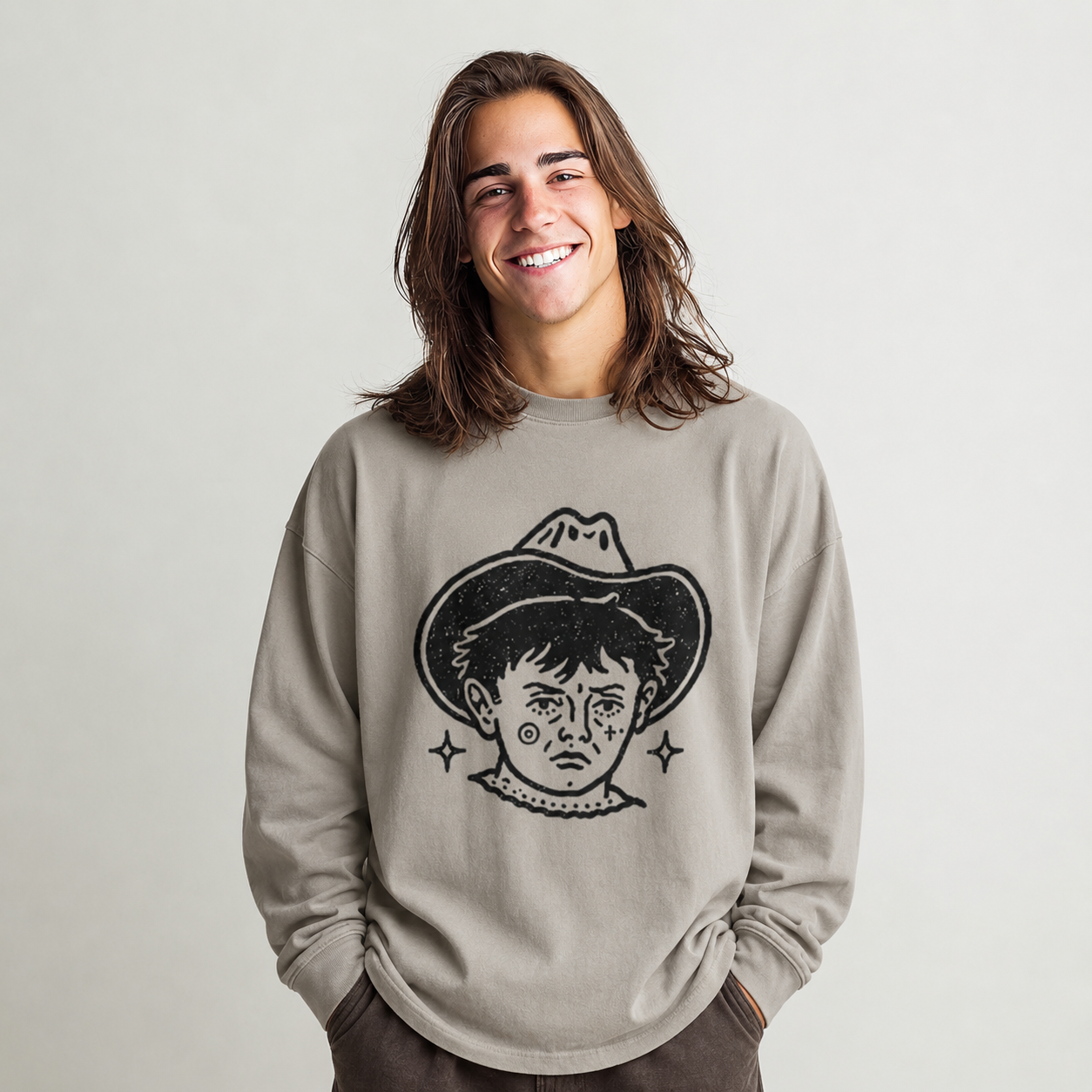 Person wearing a beige long-sleeve shirt with black graphic of a tattooed cowboy