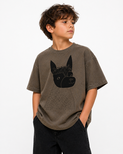 Child wearing a brown t-shirt with a black dog graphic on a white background