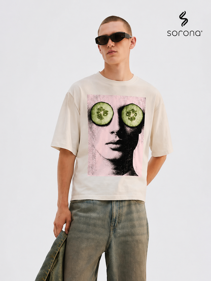Person wearing a t-shirt with a graphic design of cucumbers over eyes, standing against a plain background with 'sorona' branding.