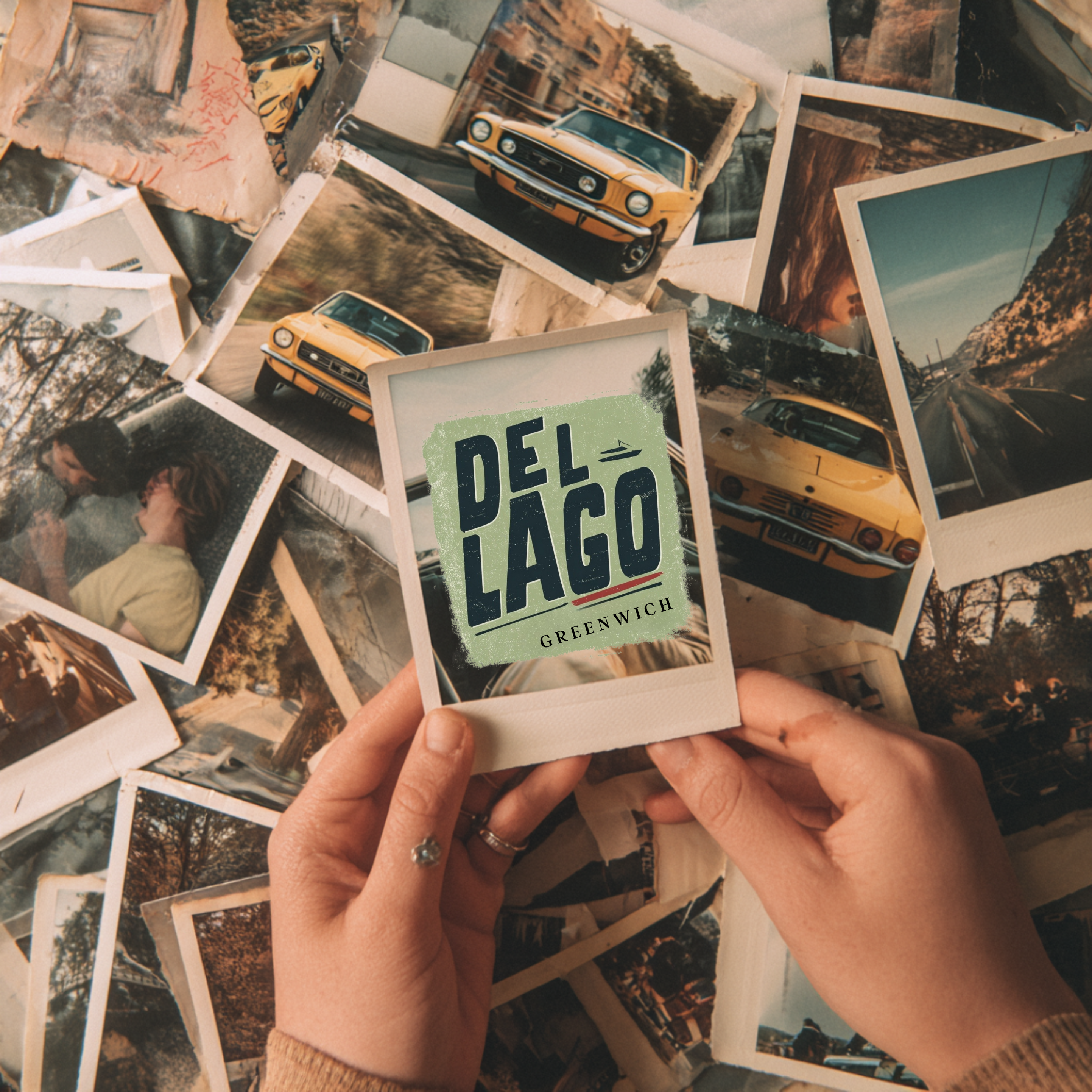 Person holding a 'Del Lago Greenwich' photo with vintage car images in the background