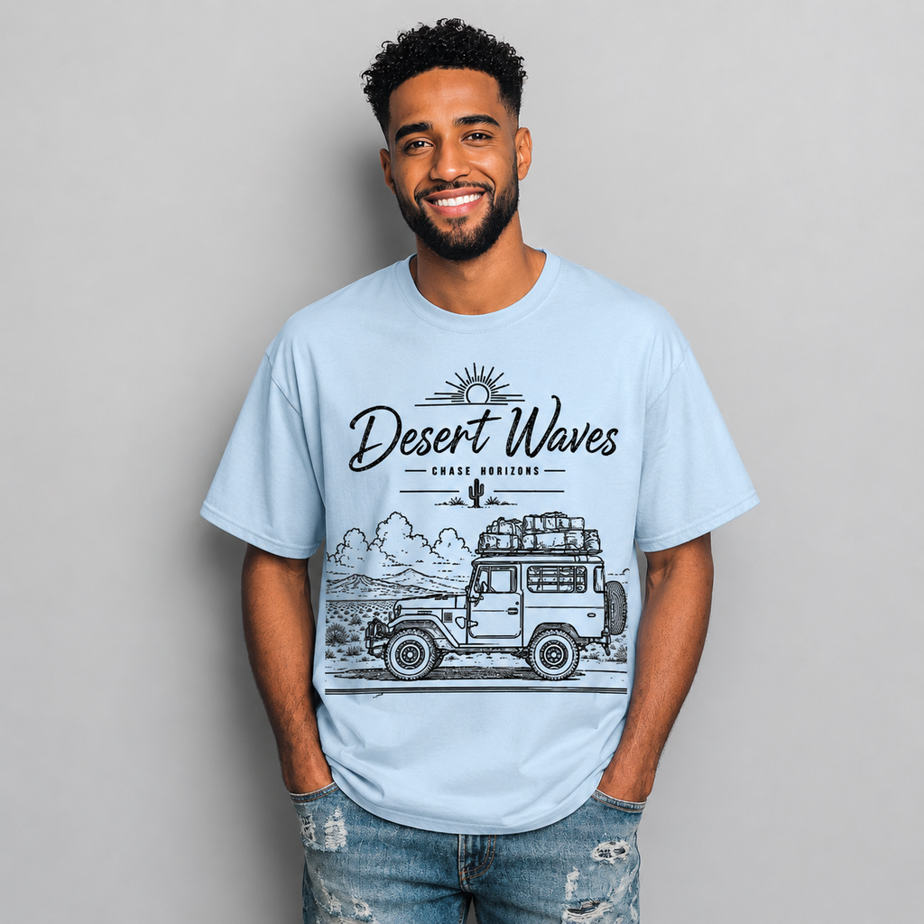 Man wearing a light blue Desert-inspired graphic t-shirt featuring artistic landscape artwork blending desert scenery with coastal influences.