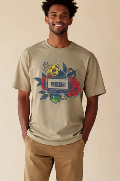 Man wearing a beige t-shirt with a colorful graphic design on a beige background