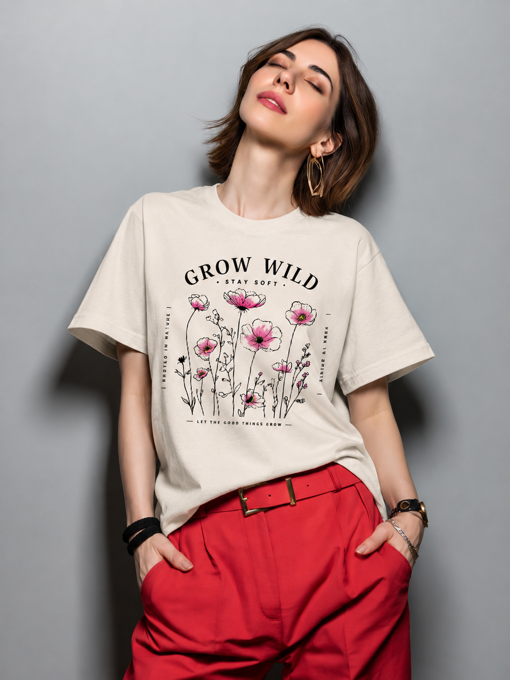 Woman wearing a Grow Wild graphic t-shirt featuring nature-inspired artwork celebrating growth, freedom, and wild beauty.