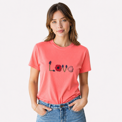 Woman wearing a coral t-shirt with 'LOVE' and heart designs on a white background