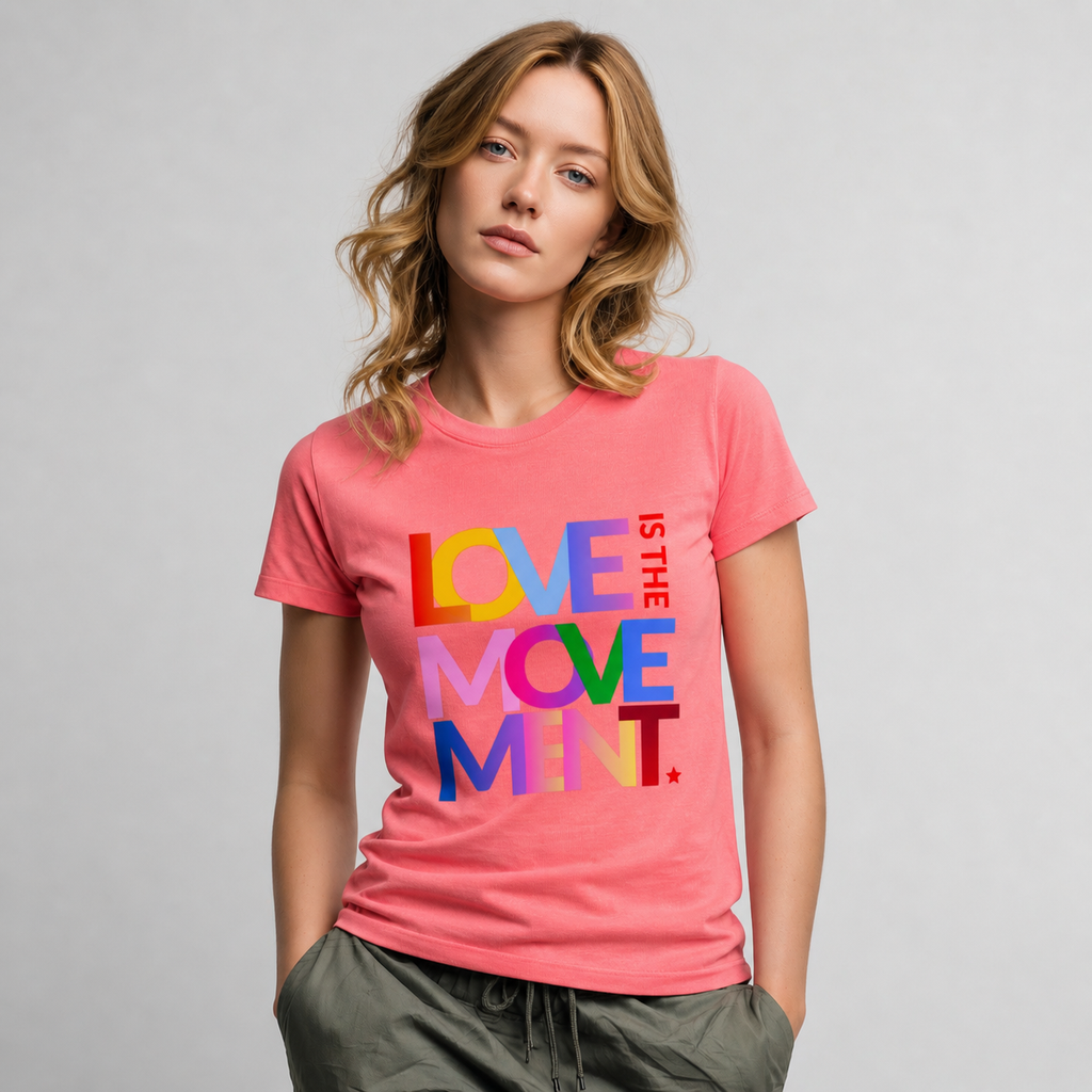 Woman wearing a pink Love Is the Movement graphic t-shirt featuring uplifting artwork inspired by kindness, unity, and positive self-expression.