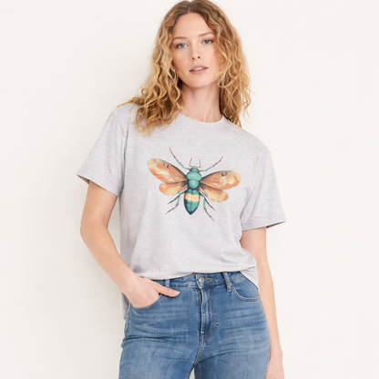 Woman wearing a gray t-shirt with a colorful bee design and blue jeans on a white background