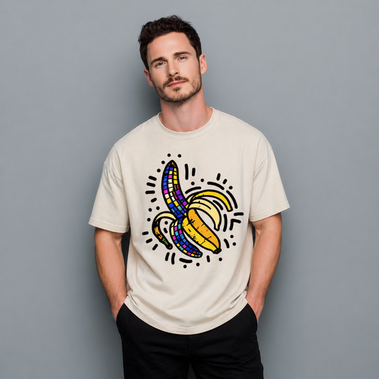 Man wearing a beige t-shirt with a colorful banana graphic on a gray background