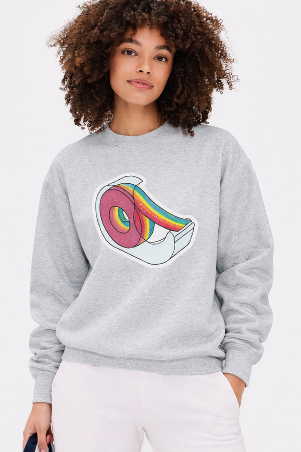 Person wearing a gray sweatshirt with a colorful design on a white background