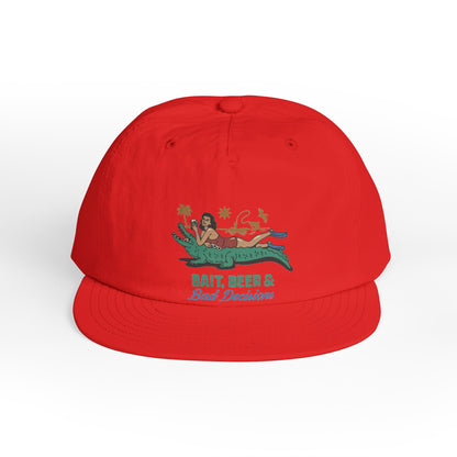 Red surfer cap featuring a retro beach graphic with tropical artwork and vintage-inspired design.