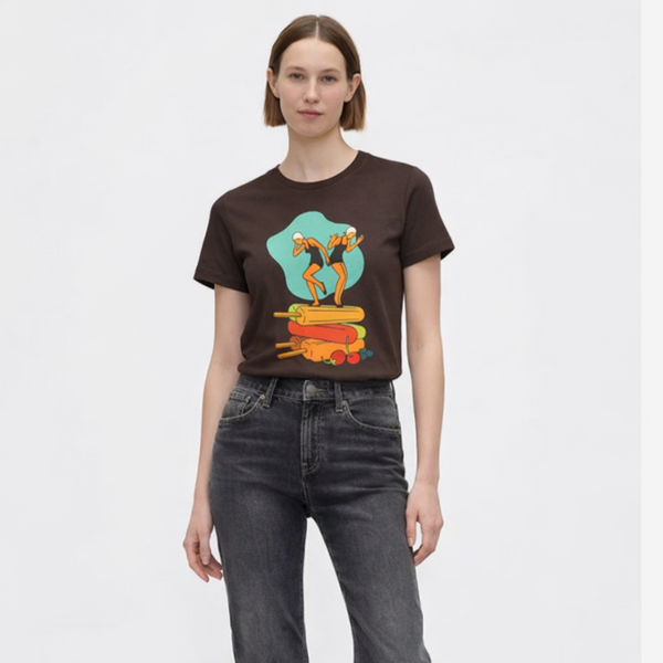 Person wearing a graphic t-shirt and dark jeans on a white background