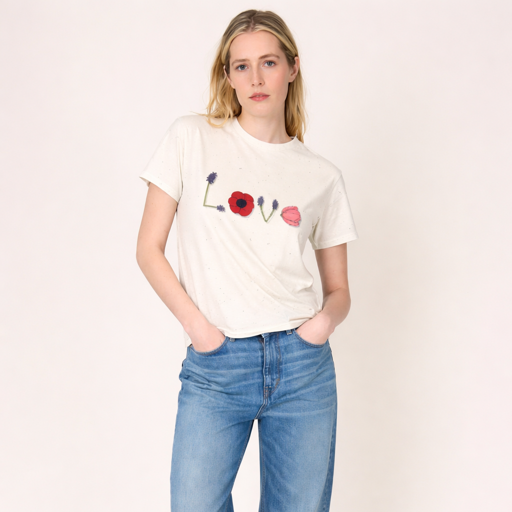 Woman wearing a white t-shirt with colorful designs and blue jeans on a white background
