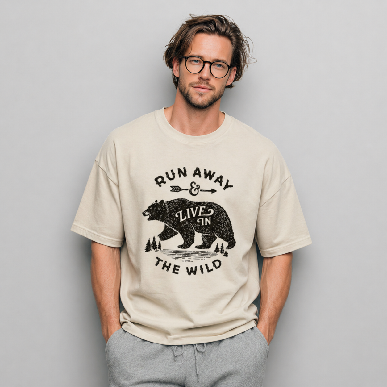 Man wearing a beige t-shirt with a bear graphic and text against a gray background