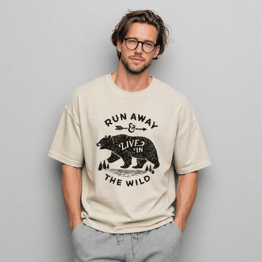 Man wearing a beige t-shirt with a bear graphic and text against a gray background