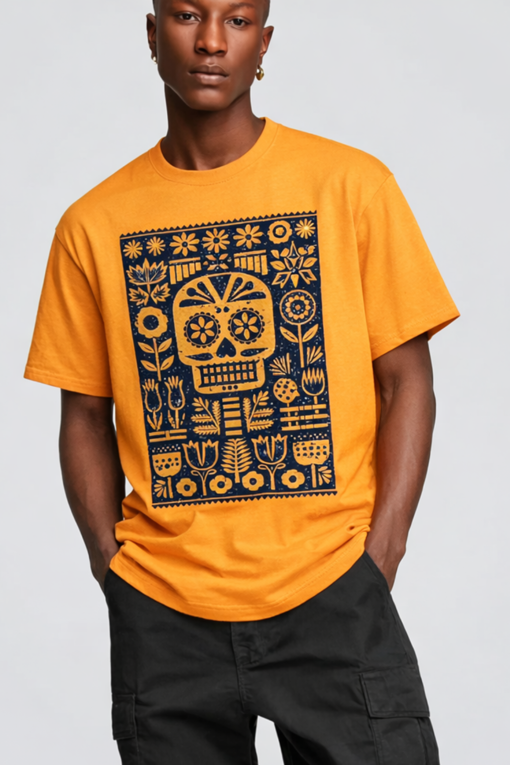 Person wearing an orange t-shirt with a black and yellow graphic design on a plain background
