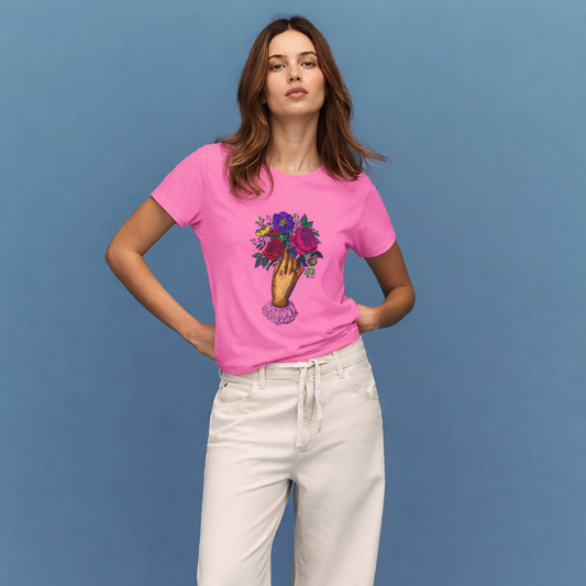 Woman wearing a pink t-shirt with a colorful design and white pants on a blue background