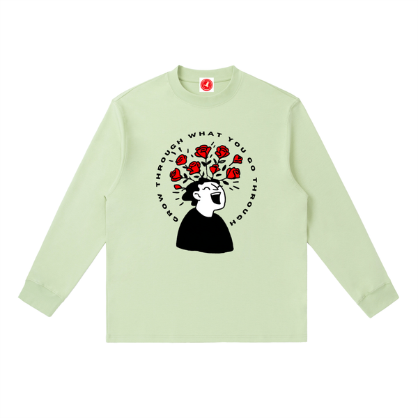 Light green long-sleeve shirt with graphic design on a white background
