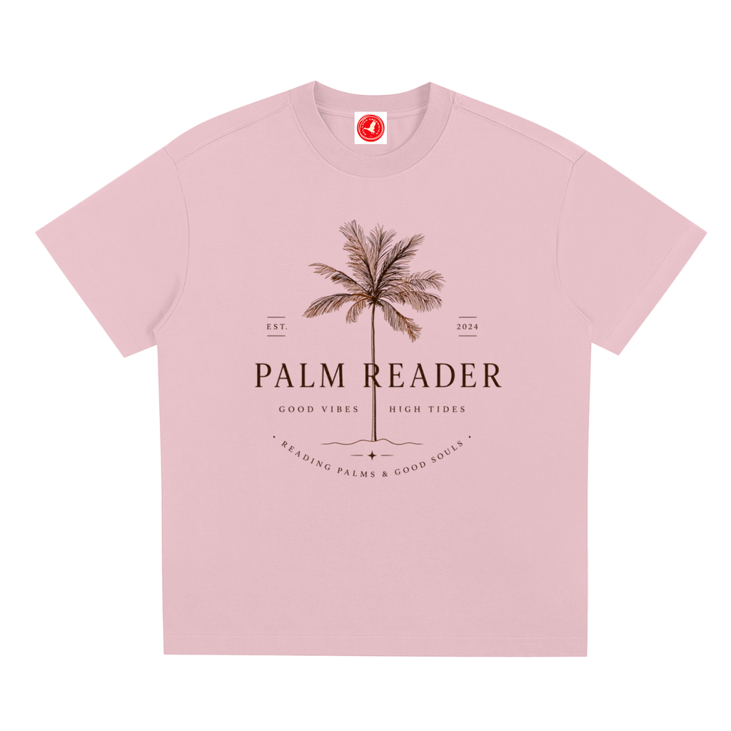 Pink Coastal graphic t-shirt featuring palm-themed artwork inspired by beach life, sunshine, and tropical escapes.