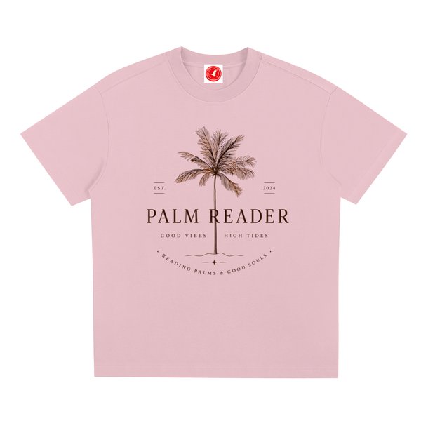 Pink Coastal graphic t-shirt featuring palm-themed artwork inspired by beach life, sunshine, and tropical escapes.