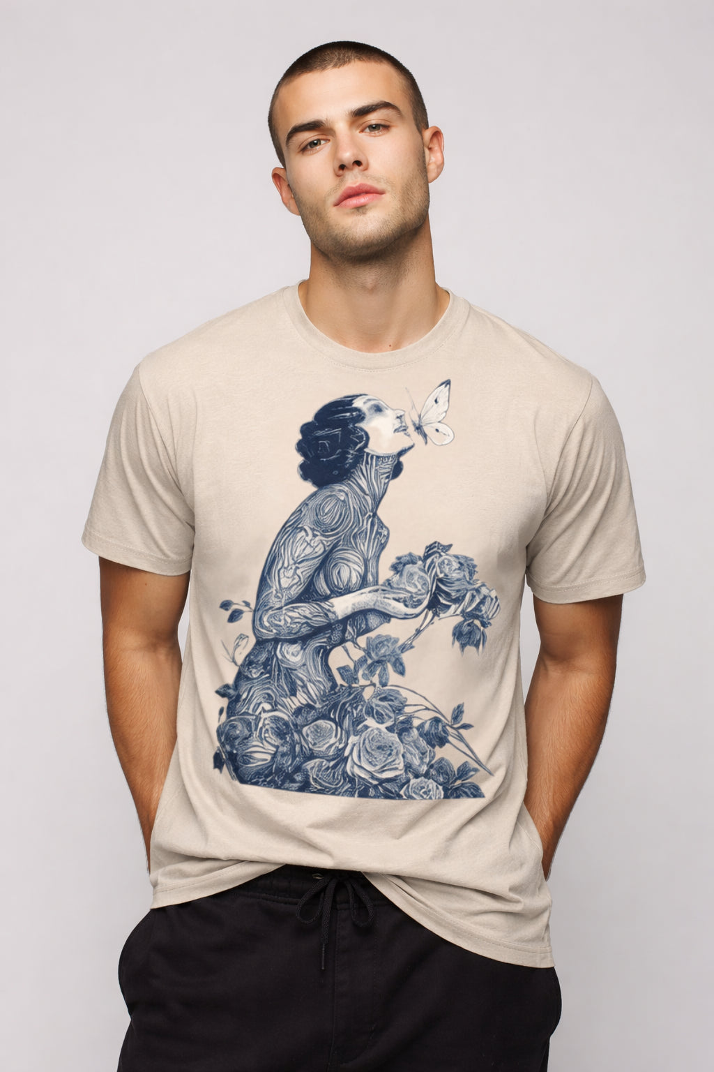 Man wearing a beigeBotanical Muse graphic t-shirt featuring botanical artwork inspired by wildflowers and vintage illustration