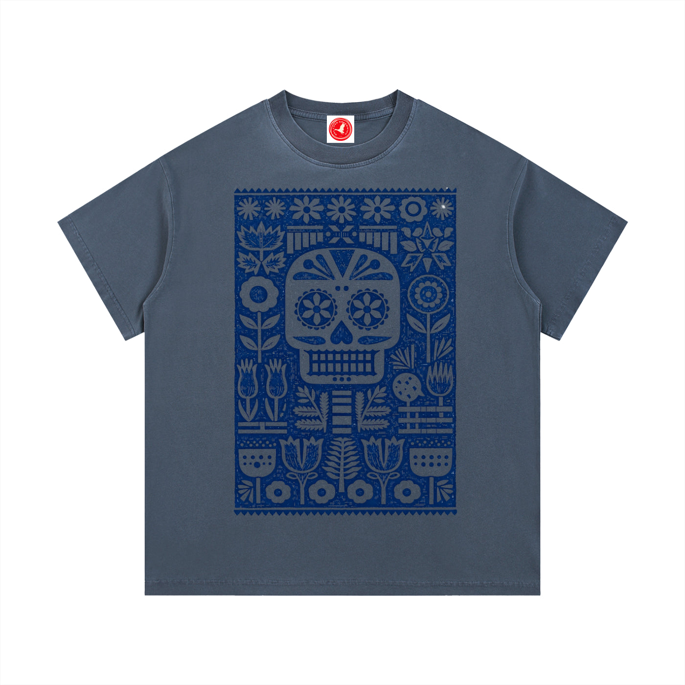 Gray Folk Skull graphic t-shirt featuring decorative skull artwork inspired by folk art and vintage illustration.