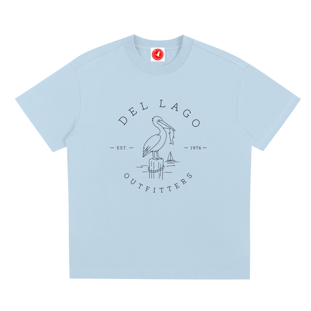 Light blue Pelican graphic t-shirt featuring original coastal bird artwork inspired by beach living and nature.