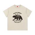 Beige Run Away and Live in the Wild graphic t-shirt featuring bear artwork inspired by wilderness, nature, and outdoor adventure.