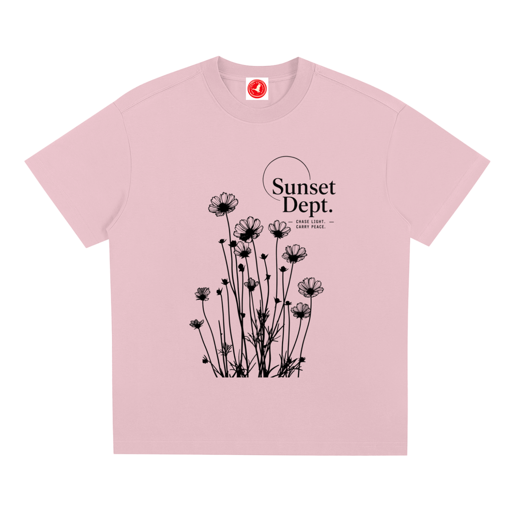 Pink Graphic t-shirt featuring sunset-inspired artwork celebrating relaxed coastal living and everyday adventure.
