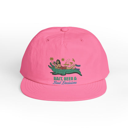 Pink surfer cap featuring a retro beach graphic with tropical artwork and vintage-inspired design.